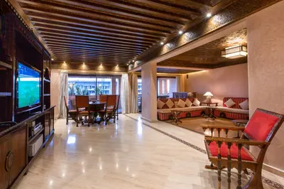 a living room with a television and a dining room at Appart de luxe Hivernage Menara Mall Gueliz in Marrakech