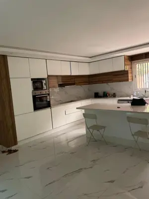 a kitchen with white cabinets and a white counter top at House of Jade Marrakech in Marrakech