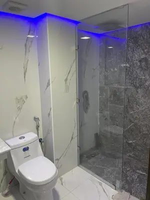 a bathroom with a toilet and a glass shower at House of Jade Marrakech in Marrakech