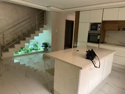 a kitchen with a counter top and a staircase at House of Jade Marrakech in Marrakech