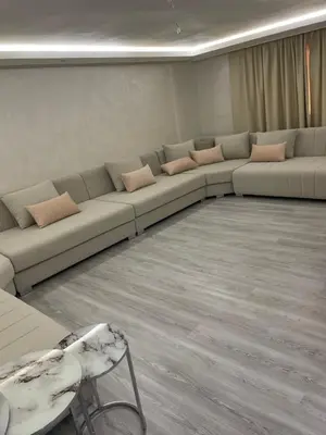 a living room with a long couch with pillows at House of Jade Marrakech in Marrakech