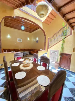 a large dining room with a table and chairs at Riyad Entier Avec piscine Red Moon Kech in Marrakech