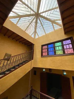 a room with two stained glass windows in a building at Riyad Entier Avec piscine Red Moon Kech in Marrakech