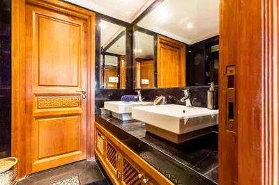 a bathroom with a sink and a large mirror at Superbe appartement calme Hivernage in Marrakech