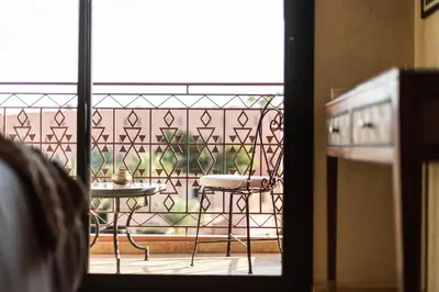 a view of a balcony with a table and a chair at Superbe appartement calme Hivernage in Marrakech