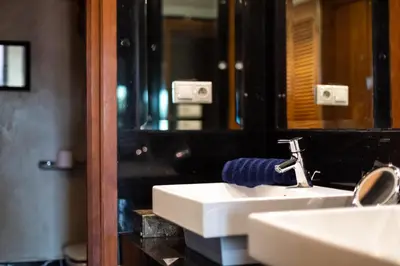 a bathroom with a white sink and a mirror at Superbe appartement calme Hivernage in Marrakech