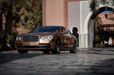 a brown car parked in front of a building at Royal Mansour Marrakech in Marrakech