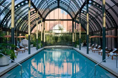 a swimming pool in a building with a glass ceiling at Royal Mansour Marrakech in Marrakech