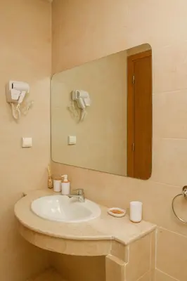 a bathroom with a sink and a mirror at Stylish Apartment with a pool in the Center of Marrakesh in Marrakech