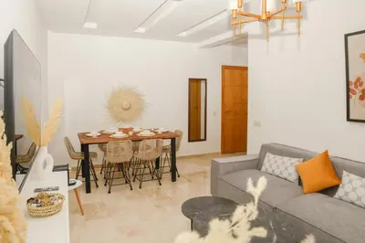 a living room with a couch and a table at Stylish Apartment with a pool in the Center of Marrakesh in Marrakech