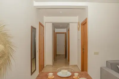 a room with a table and a hallway at Stylish Apartment with a pool in the Center of Marrakesh in Marrakech