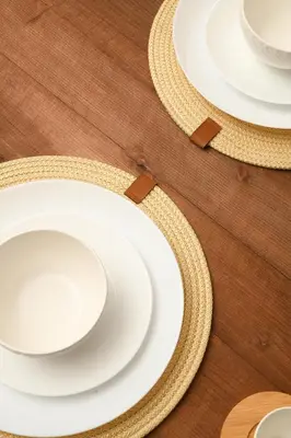 a group of white plates on a wooden table at Stylish Apartment with a pool in the Center of Marrakesh in Marrakech