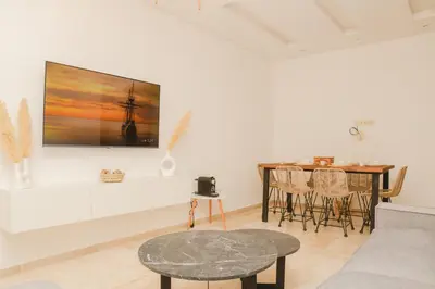 a living room with a couch and a table at Stylish Apartment with a pool in the Center of Marrakesh in Marrakech