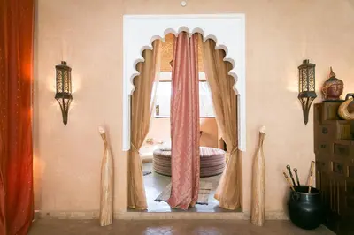 a room with a bed with curtains and a window at Lodge K in Marrakech