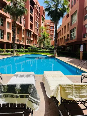 a swimming pool with two beds in a building at Résidence Mirador MAJORELLE in Marrakech