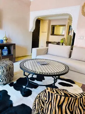 a living room with a table and a couch at Résidence Mirador MAJORELLE in Marrakech