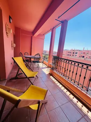 a balcony with a table and chairs on a building at Résidence Mirador MAJORELLE in Marrakech