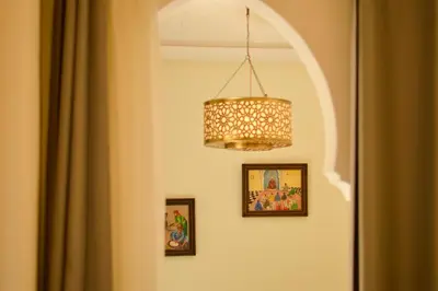 a chandelier hanging over a door with pictures at Riad Jalina in Marrakech