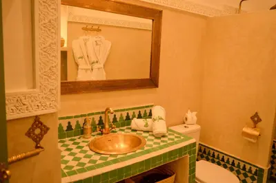a bathroom with a sink and a mirror at Riad Jalina in Marrakech