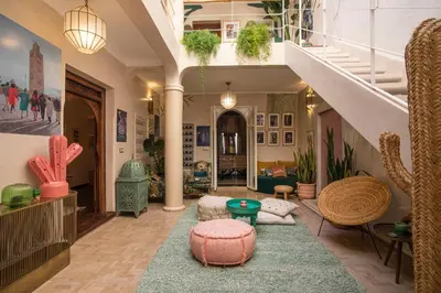 a living room with a staircase and a rug at Riad Dar Vevé - private fashion house in Marrakech