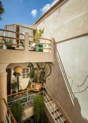 an external view of a building with stairs and plants at Riad Dar Vevé - private fashion house in Marrakech