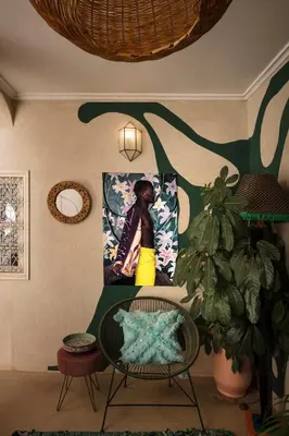a room with a picture of a woman on the wall at Riad Dar Vevé - private fashion house in Marrakech