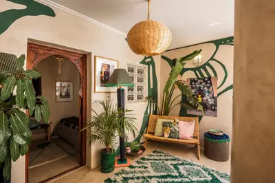 a living room with plants on the walls at Riad Dar Vevé - private fashion house in Marrakech