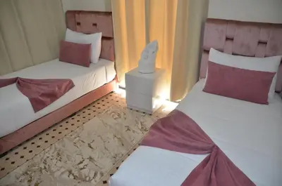 two twin beds in a room with at éden de la palmeraie in Marrakech