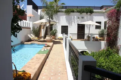 a swimming pool in the backyard of a house at Riad Clémentine in Marrakech