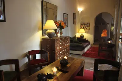 a living room with a table and a couch at Riad Clémentine in Marrakech