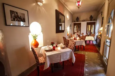 a dining room with tables and chairs in a restaurant at Riad Clémentine in Marrakech