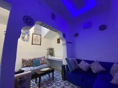 a purple living room with a couch and a table at Dwira in Marrakech
