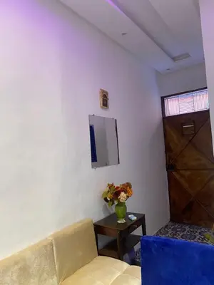 a living room with a couch and a table and a tv at Dwira in Marrakech
