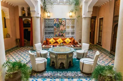 a living room with a couch and a table and chairs at Riad Manissa in Marrakech