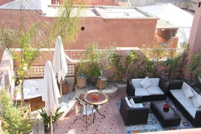 an outdoor patio with furniture and plants on a balcony at Riad Manissa in Marrakech
