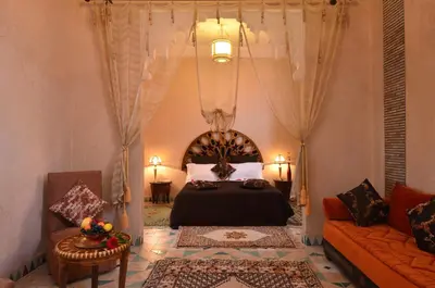 a bedroom with a bed and a couch at Riad Manissa in Marrakech