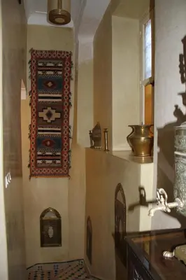 a kitchen with a wall with a wall art on it at Riad Manissa in Marrakech
