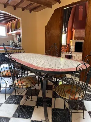 a dining room table with chairs and a table top at Dxb Riad 4 suites in Marrakech