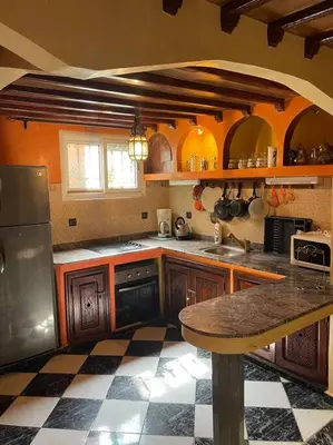 a kitchen with wooden cabinets and a counter top at Dxb Riad 4 suites in Marrakech