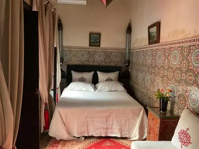 a bedroom with a large bed in a room at Riad Syba in Marrakech