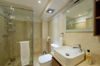a bathroom with a toilet and a sink and a shower at Duplex Haut Standing 24 in Marrakech