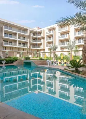 a swimming pool in front of a building at Duplex Haut Standing 24 in Marrakech