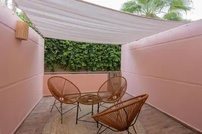 a patio with two chairs and a table at Duplex Haut Standing 24 in Marrakech