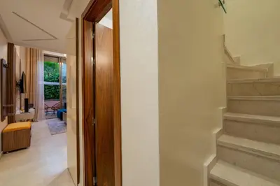 a hallway with stairs leading to a living room at Duplex Haut Standing 24 in Marrakech