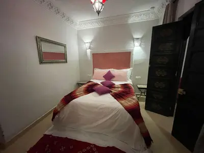 a bedroom with a bed with a bow on it at Dar Nossa in Marrakech