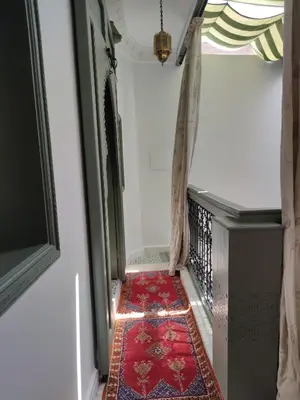 a hallway with a red rug on the floor at RZ22, 5 min de Jemaa El Fna, 4 Pers, Fibre Optique Wi-Fi in Marrakech