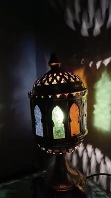 a lantern sitting on top of a table at Riad à Marrakech dans la Résidence Touristique Al Qaria Assiyahia in Marrakech