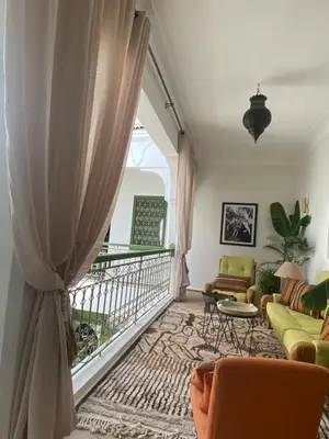 a living room with a couch and a window at Riad Dar Adal exclusivité 2 à 6 personnes petit déjeuner compris place jemaa El fna in Marrakech