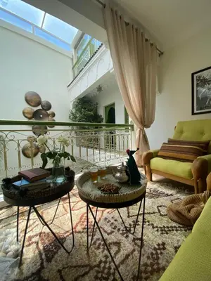 a living room with a couch and a table at Riad Dar Adal exclusivité 2 à 6 personnes petit déjeuner compris place jemaa El fna in Marrakech