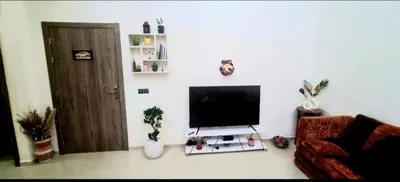 a living room with a flat screen tv on a wall at charming room close to Marrakech airport in Marrakech
